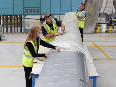 Unwrapping the left aileron from its protective covering. Nov 2016.